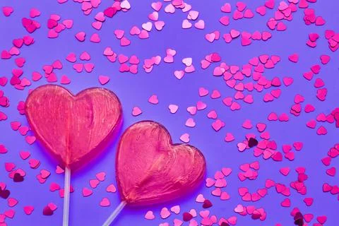 Valentines Day background. Two candy hearts with glitter on purple backdrop. Top Stock Photos