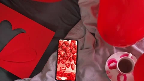 Valentine's Day breakfast composition with heart-shaped balloons, coffee cup, an Stock Footage 298184646