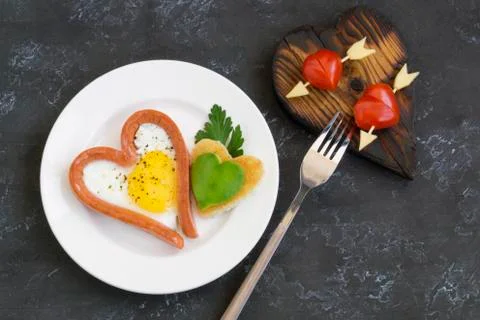 Valentine's day Breakfast is scrambled eggs with heart-shaped bread. The view Stock Photos