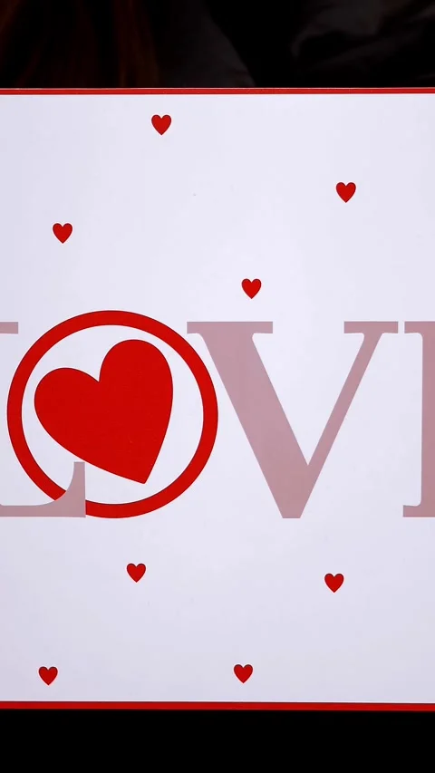 Valentine's Day. close-up. holding in hands a poster with the inscription love. Stock Footage 314115038