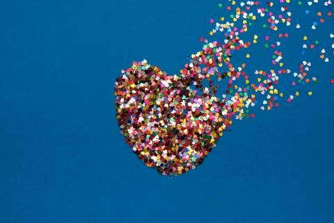 Valentines day composition with broken heart made from confetti on classic blue Stock Photos