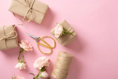 A Valentine's Day composition of eco-packaged gifts, a kraft envelope and fre Stock Photos