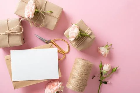 A Valentine's Day composition of eco-packaged gifts, a kraft envelope and fresh Stock Photos