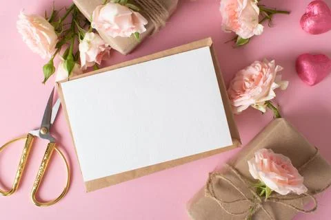 A Valentine's Day composition of eco-packaged gifts, a kraft envelope and fresh Stock Photos