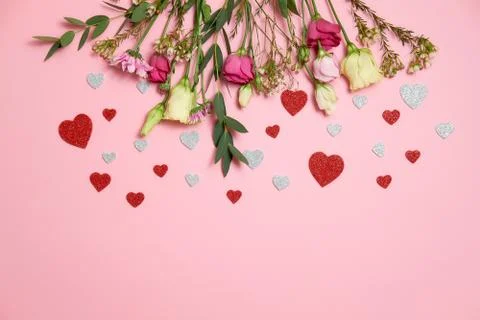 Valentines day composition : flowers and heart shaped valentines card confett Stock Photos