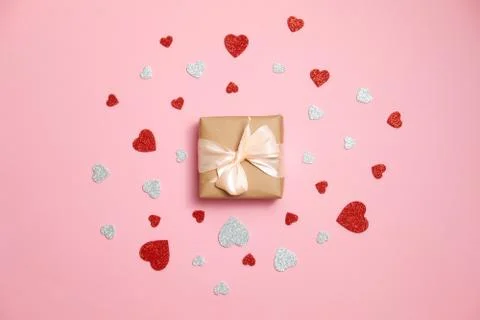 Valentines day composition : gift box packed in kraft paper with ribbon bow a Stock Photos