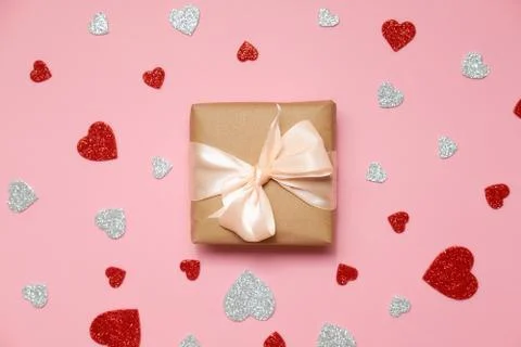 Valentines day composition : gift box packed in kraft paper with ribbon bow a Stock Photos