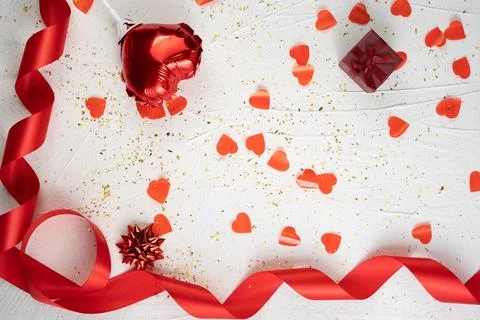 Valentines day composition with gift box, hearts and red ribbon on white back Stock Photos