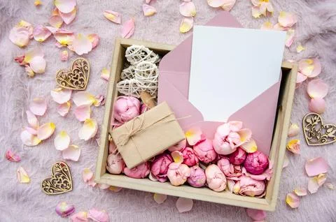 Valentine's Day composition. Gift box with craft blank card, envelope, rose buds Stock Photos