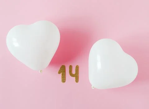 Valentines day composition. Pink background with white heart shape baloons... Stock Photos