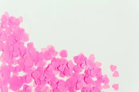 Valentines day composition. White background with pink heart shape confetti.. Stock Photos