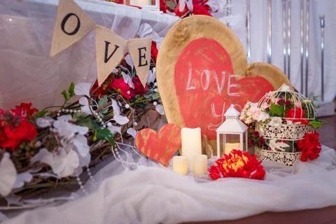 Valentine`s day decorative elements, bird cage, flowers, wooden hearts Stock Photos