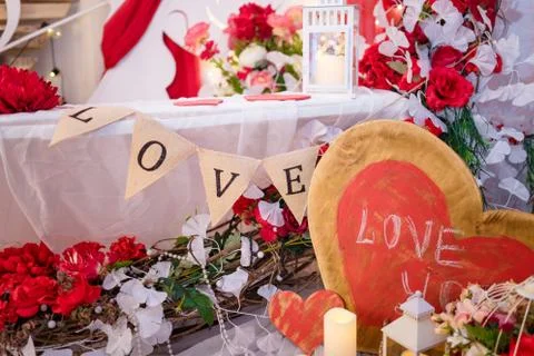 Valentine`s day decorative elements, bird cage, flowers, wooden hearts Stock Photos