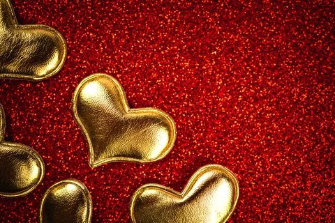 Valentines day flat lay background with hearts on a red glitter. Top view and Stock Photos