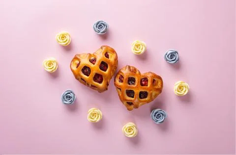 Valentines Day flat lay. Two heart-shaped buns with berry jam and lattice crust Stock Photos