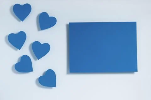 Valentine's day frame composition. Blue hearts blank sheet of paper. Top view Stock Photos