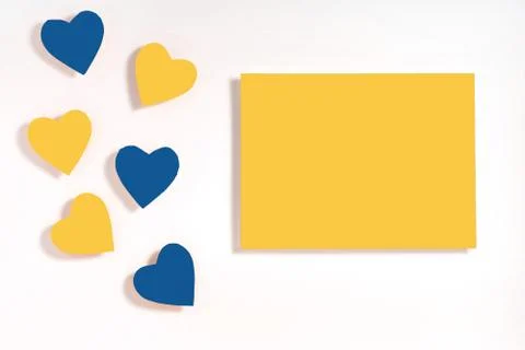 Valentine's day frame composition. Blue and yellow hearts blank sheet of pape Stock Photos