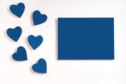 Valentine's day frame composition. Blue hearts blank sheet of paper on white  Stock Photos