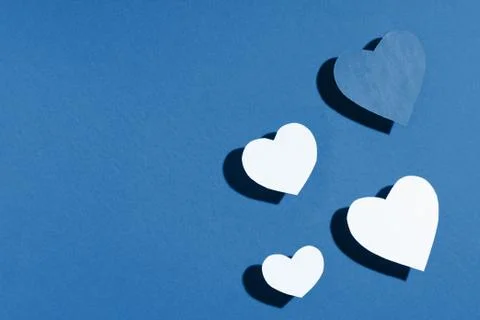 Valentine's day frame composition. Blue paper hearts on blue background. Top Stock Photos