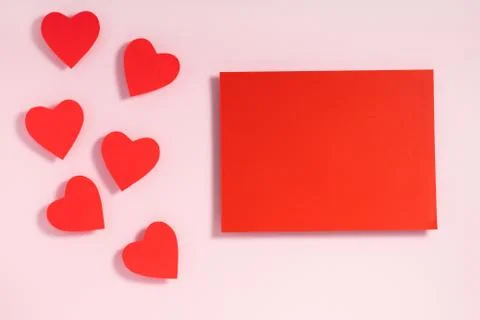 Valentine's day frame composition. Red hearts blank sheet of paper on pastel  Stock Photos