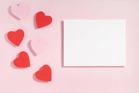 Valentine's day frame composition. Red pink hearts blank sheet of paper on pa Stock Photos