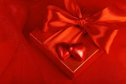 Valentine's Day. Gift candy in the form of a heart on a red background Stock Photos