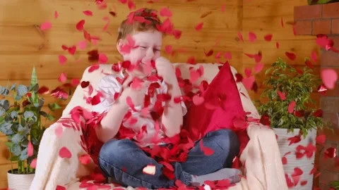 Valentine's Day kids. Cute little blond boy rejoices with flying red heart shape Stock Footage 169952653