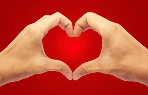 Valentines day - making heart with 2 hands on red background Stock Photos
