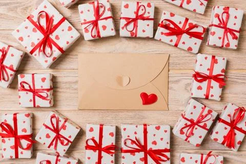 Valentines day romantic background. envelope card with gift boxes and heart o Stock Photos
