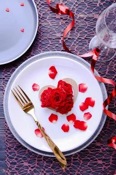 Valentine's Day Serving. Beautiful table setting with scarlet roses Stock Photos