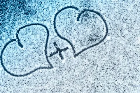 Valentine's Day. Soft focus. Background. Close-up.Heart drawn in the snow. Stock Photos