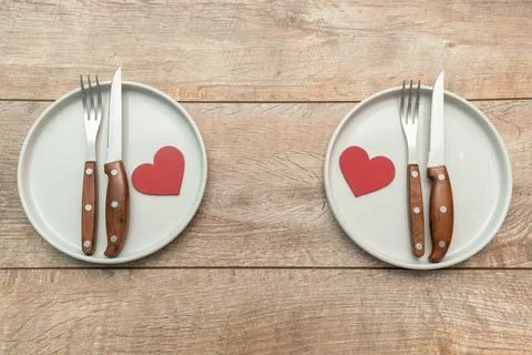 Valentine's Day tabble serving with plates and silverware on rustic wooden .. Stock Photos