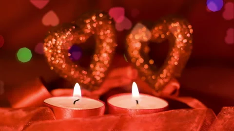 Valentines day,  two candles burning in front of hearts, closeup Stock Footage 45658178