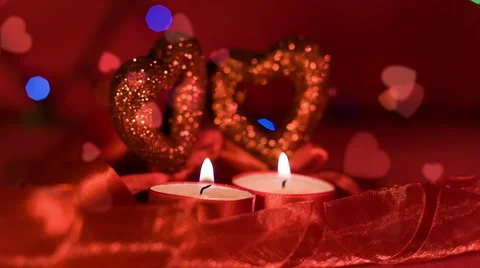Valentines day,  two candles burning in front of hearts Video stock 45658192