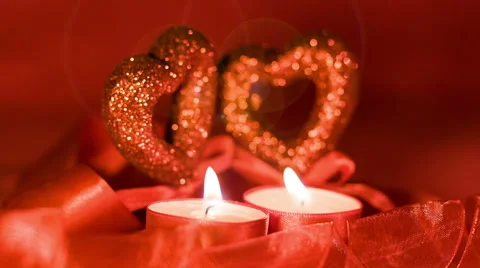 Valentines day, two candles burning in front of hearts, closeup Stock Footage 45658221