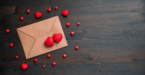 Valentines day wooden background with envelope and red hearts Stock Photos