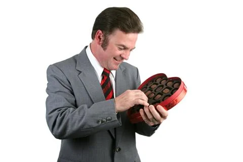 Valentines Guy - Selecting a Chocolate Stock Photos