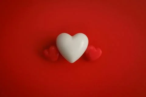 Valentine's hearts on red background with copy space. Symbol of love. Stock Photos