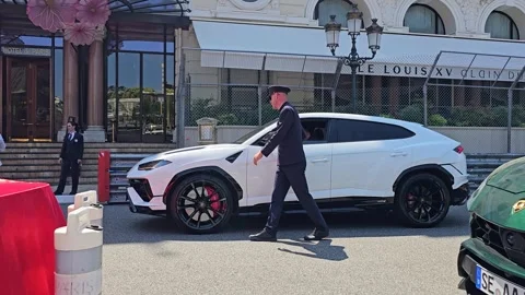 Valet Opens Door of White Lamborghini Urus SUV Stock Footage 308229142