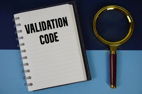 Validation Code text written on notebook paper with magnifying glass Stock Photos