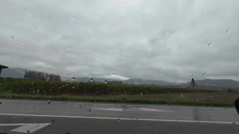Vall d'en Bas, Spain; October 4 2026: Driving through rainy Vall d'en Bas c.. Stock Footage 347674038