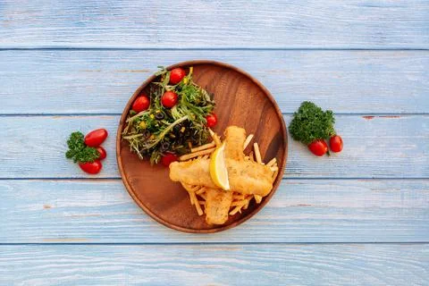 Valle Battered Cod Fish And Chips with salad, lime and cherry tomato Served i Stock Photos