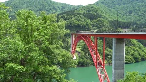 Valley behind the mountain and red bridge early summer JAPAN Stock Footage 108492934