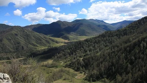 The valley between the mountains with a serpentine mountain road 스톡 동영상 71548068