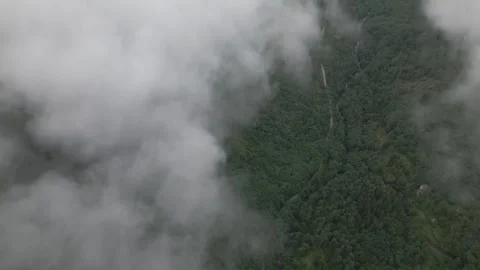 Valley with clouds aerial pan up Stock Footage 252257333