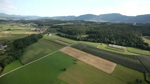 Valley with fields, meadows, forest and few houses aerial shot Stock Footage 27823114