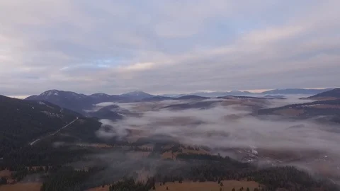Valley in the fog with mountains in the background Stock Footage 87997474