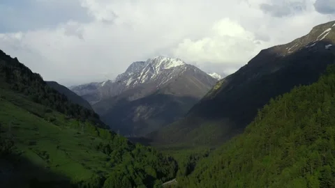 Valley with a mountain in the background and a river running through it, with Stock Footage 243089768
