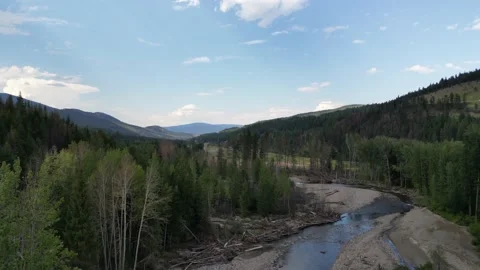 Valley raise down onto riverbed on a summer days Stock Footage 219597593