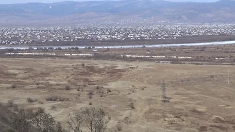 Valley of the river, behind the river a village Stock Footage 75557240